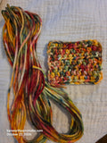 Falltide hand-dyed organic cotton yarn skein with crocheted swatch